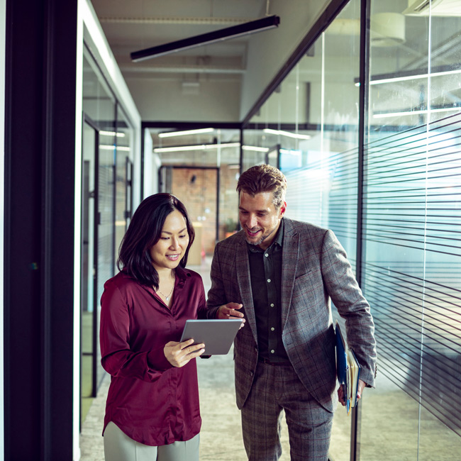 Two people looking at iPad business services