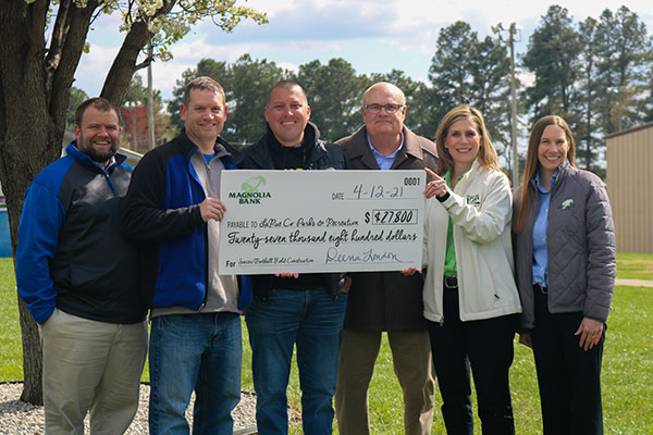 6 Magnolia Bank employees holding a prize check poster