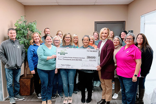 Five people holding a large scholarship cardboard check